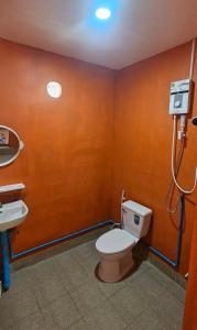 a bathroom with a toilet and a sink at Farm Bungalow in Ao Nam Mao