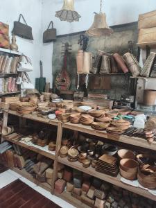 a shelf filled with lots of pots and pans at Lentera Lombok in Tetebatu +73 photos