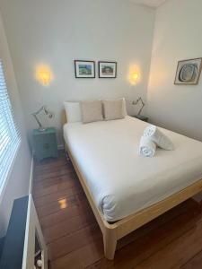 a bedroom with a large bed with two lamps on it at Blackheath Nook in Blackheath