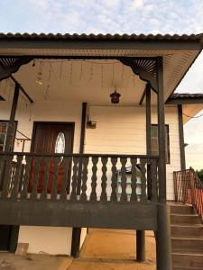 a house with a front porch with a railing at De JITRA 2 HOMESTAY in Jitra