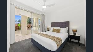 a bedroom with a large bed and a window at Palazzo Colonnades in Gold Coast