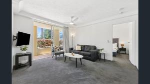 a living room with a couch and a table at Palazzo Colonnades in Gold Coast