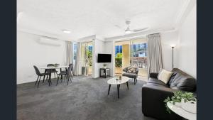 a living room with a couch and a table at Palazzo Colonnades in Gold Coast +76 photos