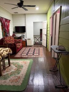 a living room with a couch and a table at De JITRA 2 HOMESTAY in Jitra