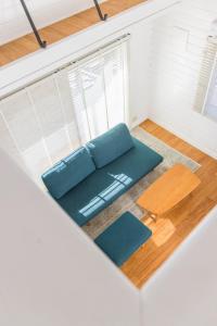 a living room with a couch and a table at jfハウス - カフェ併設の一棟貸切で楽しむプライベートステイ - サーフポイントまで徒歩5分 in Ichinomiya