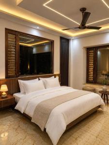 a bedroom with a large bed with a ceiling fan at The Tranquil hotel in Chakrāta +61 photos