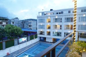 a view from the balcony of a building with a swimming pool at Lotus Shines & Amenities in Manamaiju