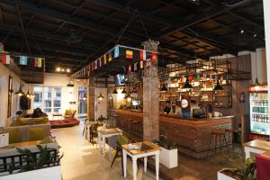 a restaurant with a bar and tables and chairs at Lotus Shines & Amenities in Manamaiju