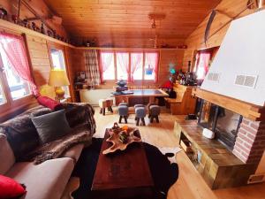 a living room with a couch and a fireplace at Alp Chnorz Penthouse in Nesslau