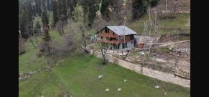 an aerial view of a house on a hill at Jungle Bungalow in Pahalgām