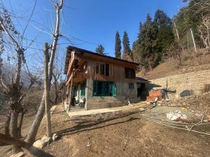 a house on the side of a hill at Jungle Bungalow in Pahalgām