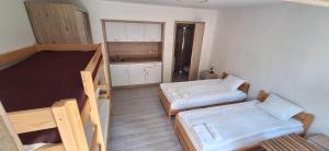 a small room with two beds and a kitchen at Borowik Milicz in Milicz