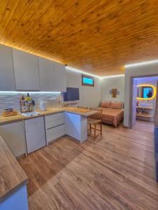 a kitchen with a table and a couch in a room at Vista Mare 2 in Kámpos +8 photos