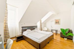 a bedroom with a large bed in a room at Hotel Trinity in Olomouc