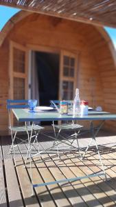 a table sitting in front of a house at Su Niberalzu glamping in Fermata di Enas