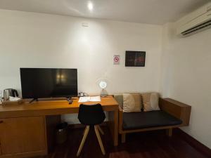 a desk with a computer and a chair in a room at Mango Tree Resort in Chiang Mai +35 photos