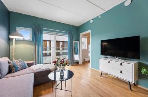 a living room with a couch and a flat screen tv at City apartment in Alta