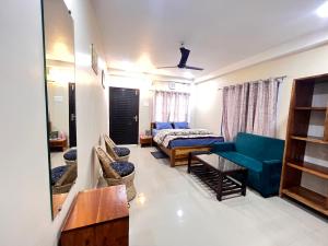 a living room with a blue couch and a bed at YNL HOMESTAY a boutique hotel in Dirang Dzong +21 photos