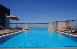 a large swimming pool on top of a building at Warwick Hotel Al Safa - Jeddah in Jeddah