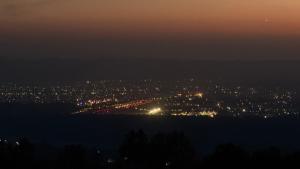 a view of a city lit up at night at M2LambardaarStay in Kandogal