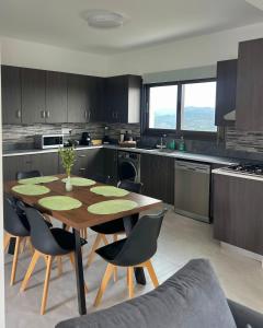a kitchen with a wooden table and chairs in it at Villa Terra Rosa in Kritou Terra