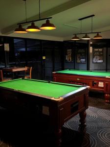 a billiard room with a pool table and two tables at Criterion Hotel Gundagai in Gundagai
