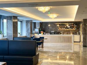 a bar in a hotel lobby with blue chairs and a counter at ANMAN HHBB tourism & business rooms in Padova