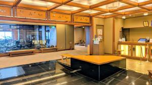a large room with a table in the middle at 夫婦露天風呂の宿吟松 in Ibusuki