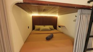 a small bedroom with a bed in a small room at Nira Hostel Kuta Lombok in Kuta Lombok
