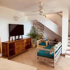 a living room with a flat screen tv at Villa Chiara Beachfront Las Terrenas in El Limón