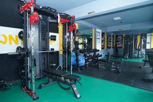 a gym with treadmills and machines in it at Lotus Shines & Amenities in Manamaiju