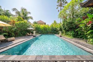 a swimming pool in the middle of a resort at Bali Dream Garden - Tropical Escape with Pool & Spa in Ubud