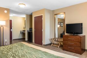 a hotel room with a bed and a flat screen tv at Comfort Inn Lancaster County in Columbia