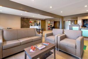 a living room with two couches and a table at Quality Inn Mishawaka - South Bend in Mishawaka