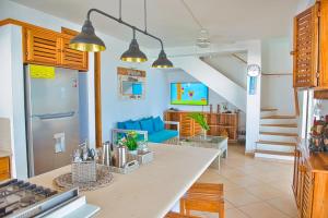 a kitchen and living room with a couch and a table at Villa Chiara Beachfront Las Terrenas in El Limón