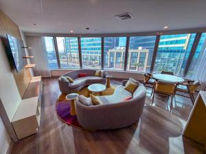 a living room with couches and a large window at Radisson Hotel Trinidad in Port-of-Spain