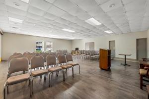 a room with rows of chairs and a podium in it at Rodeway Inn Monroe in Monroe