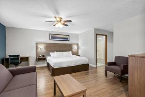 a hotel room with a bed and a couch at Quality Inn Neosho in Neosho