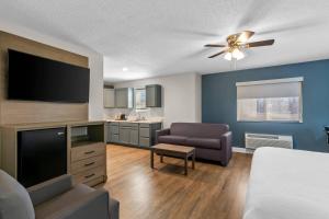 a living room with a bed and a flat screen tv at Quality Inn Neosho in Neosho