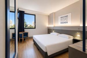 a hotel room with a bed and a window at Hotel Martini in Verona +85 photos