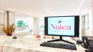 a computer monitor sitting on top of a counter at Hotel Naica in Rimini