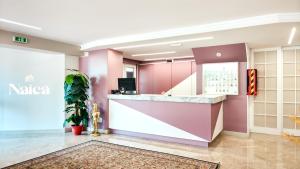 a lobby of a naria store with a counter at Hotel Naica in Rimini