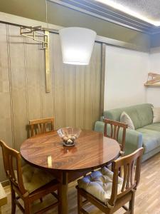 a dining room with a table and a couch at Pescasseroli Home in Pescasseroli