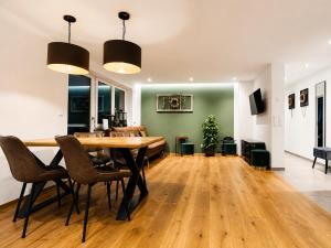 a dining room with a wooden table and chairs at Apartment Ihm in Memmingen