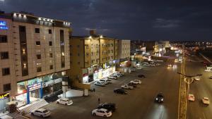 a city at night with cars parked on a street at Qimam Park Abha 2 in Abha