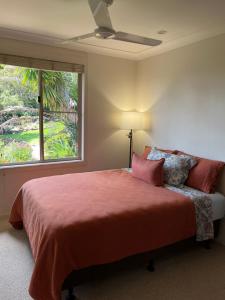 a bedroom with a large bed and a window at Bexhill Grace in Lismore