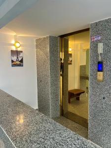 a lobby with a walk in shower and a glass door at A Z Hotel Phnom Penh in Phnom Penh