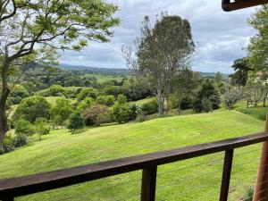 a view from the balcony of a house with a green field at Bexhill Grace in Lismore +11 photos