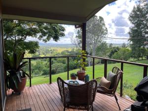 a porch with chairs and a table with a view at Bexhill Grace in Lismore