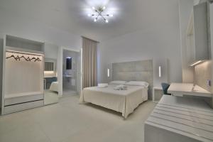 a white bedroom with a bed and a couch at Hotel da ettore in Porto Cesareo +83 photos